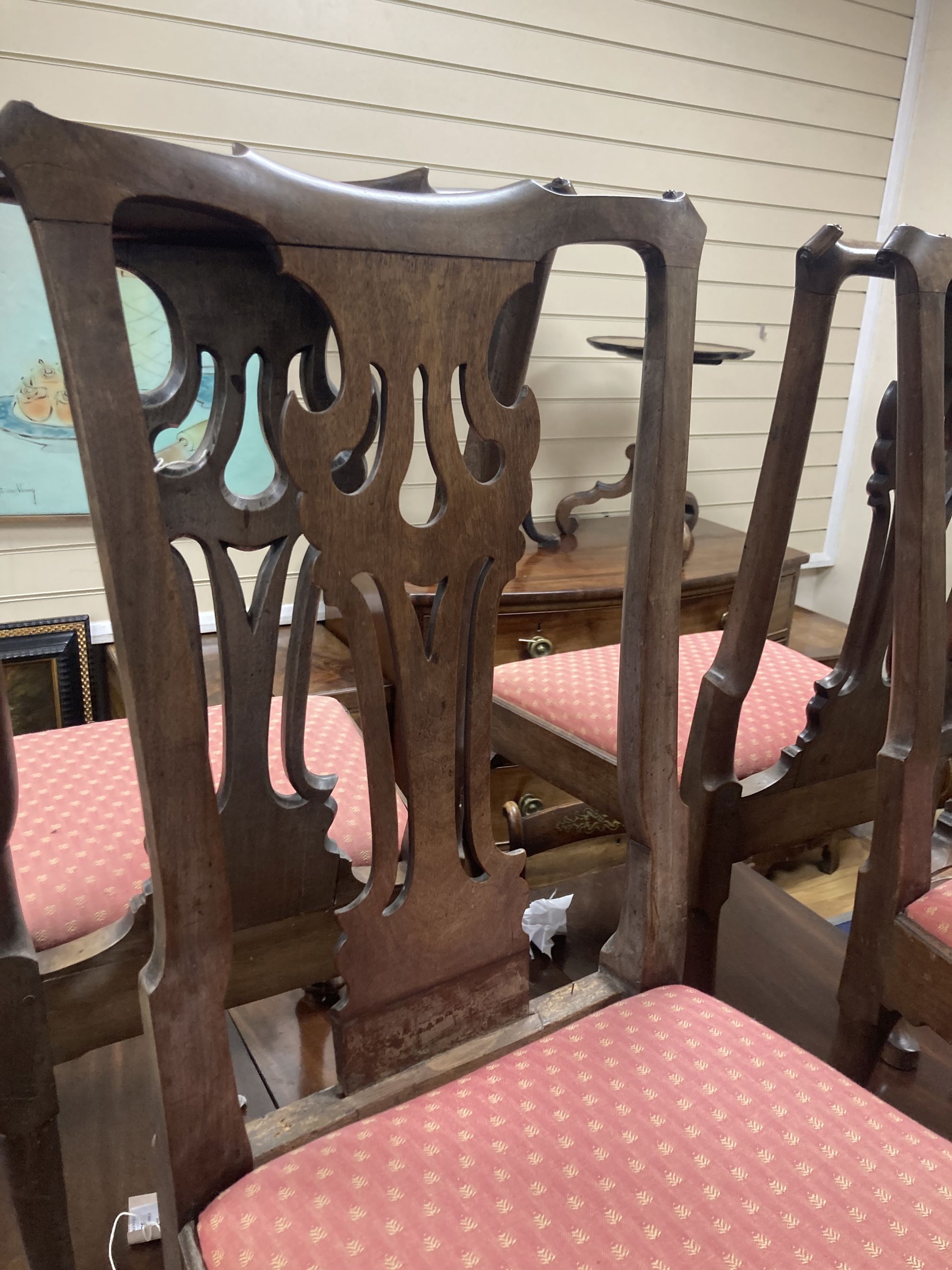 A set of four mid-18th century walnut / mahogany dining chairs